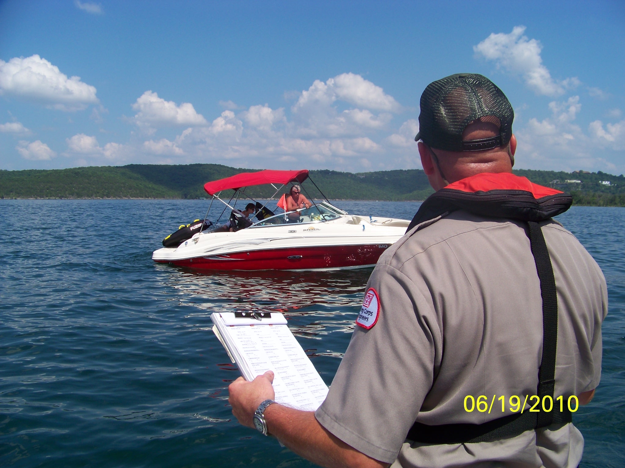 Ranger inspecting boater