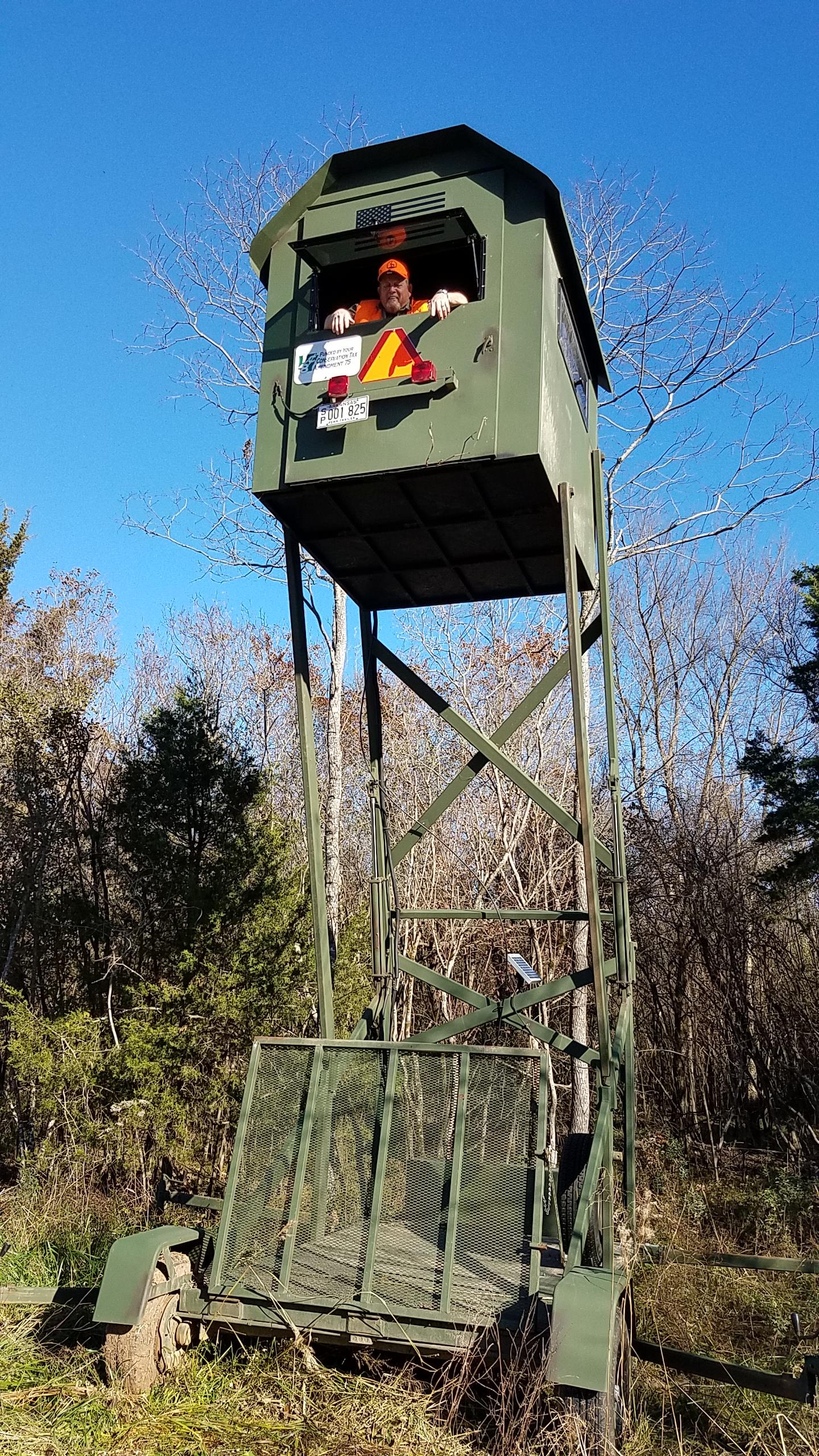 man in an elevated deer stand man in an elevated deer stand